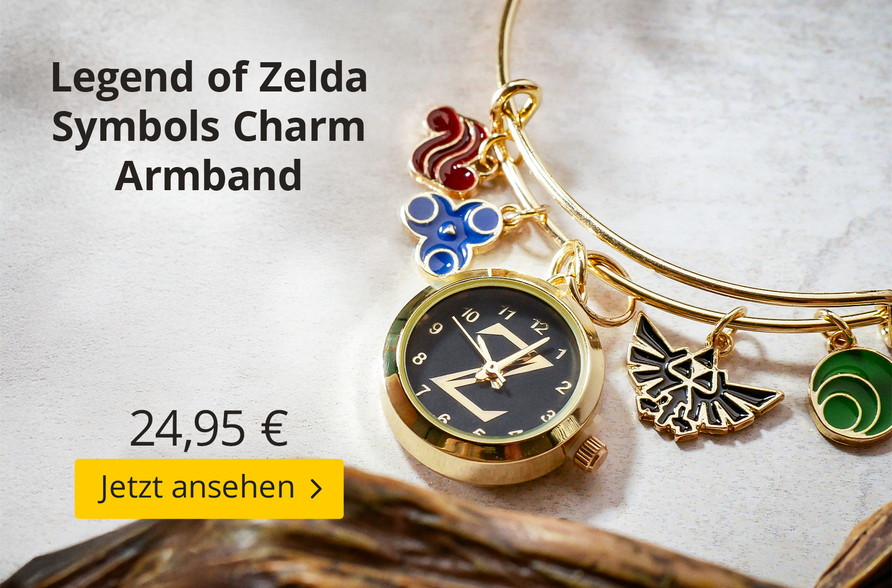 Goldfarbenes Armband mit mehreren „The Legend of Zelda“-Charms, darunter Symbole in Rot, Blau und Grün sowie ein Hyrule-Wappen und eine kleine Uhr mit schwarzem Ziffernblatt und Zelda-Logo. Text: Legend of Zelda Symbols Charm Armband – 24,95 €, Jetzt anse