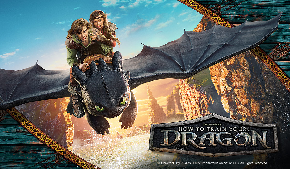 Two young riders fly on Toothless the dragon above a rocky coast. The “How to Train Your Dragon” logo appears below.
