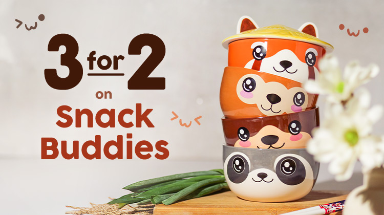 Four colourful snack bowls with cute animal faces stacked on a kitchen table. Text: 3 for 2 on Snack Buddies. Elbenwald promo graphic.
