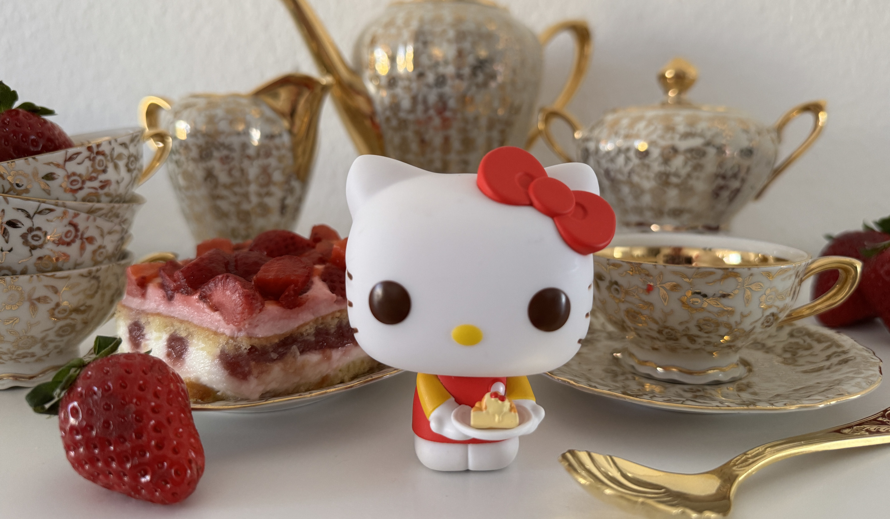 Hello Kitty Funko POP figure in red dress with dessert, strawberry cake, tea set and strawberries.