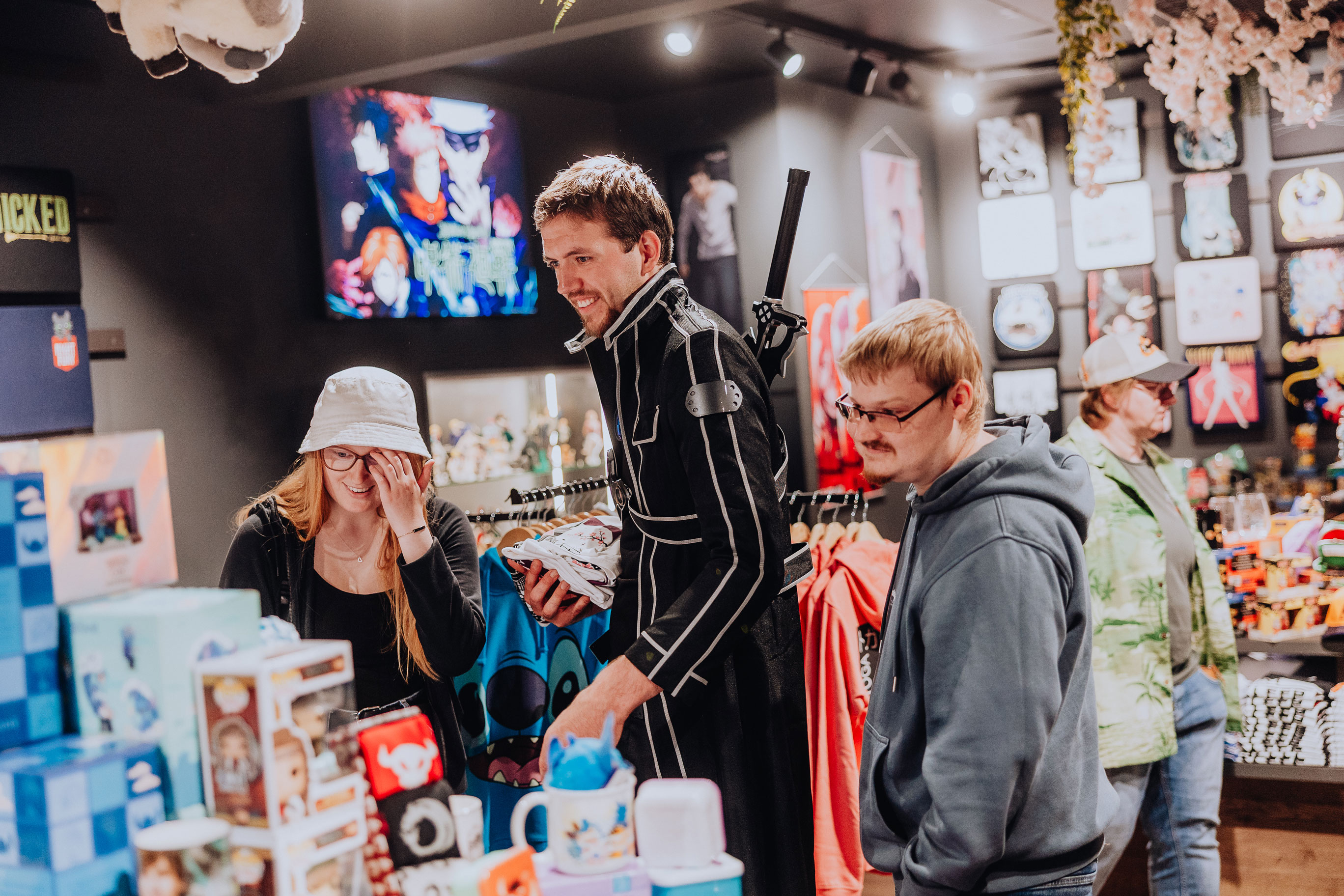 Three customers, some in costume, gaze in awe at the merchandise in the Elbenwald store.