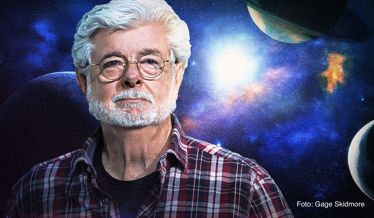 Portrait of George Lucas against a space background with planets and stars, wearing glasses and a plaid shirt, looking at the camera. Photo by Gage Skidmore.