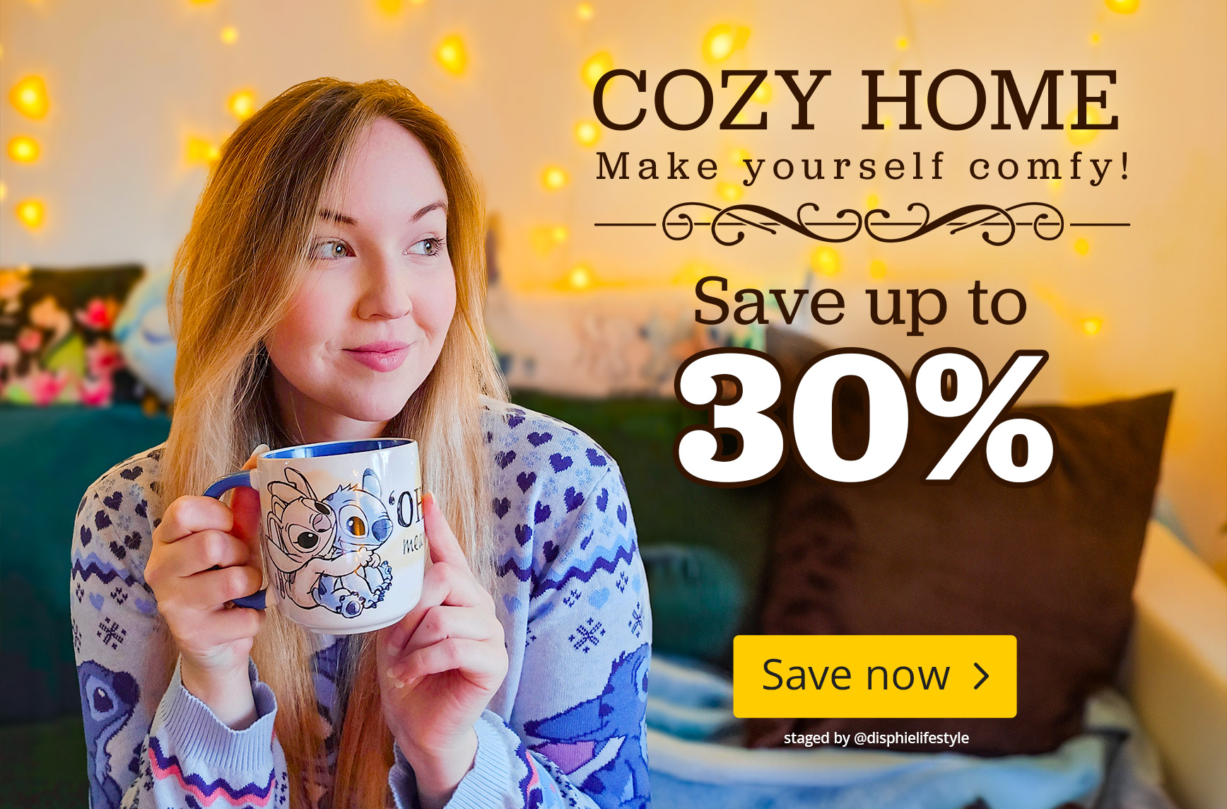 Cosy home scene with a woman in a Lilo & Stitch pyjama holding a Stitch mug. Warm fairy lights in the background. Text: Cozy Home, make yourself comfortable, save up to 30 percent, Save now.