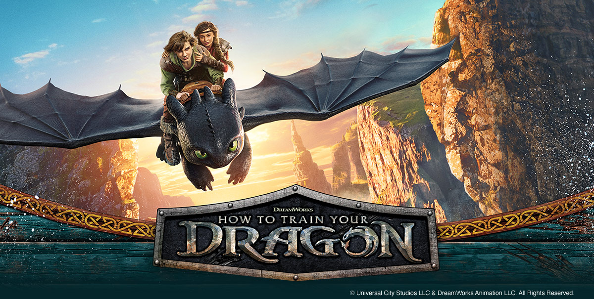 Two young riders fly on Toothless the dragon above a rocky coast. The “How to Train Your Dragon” logo appears below.