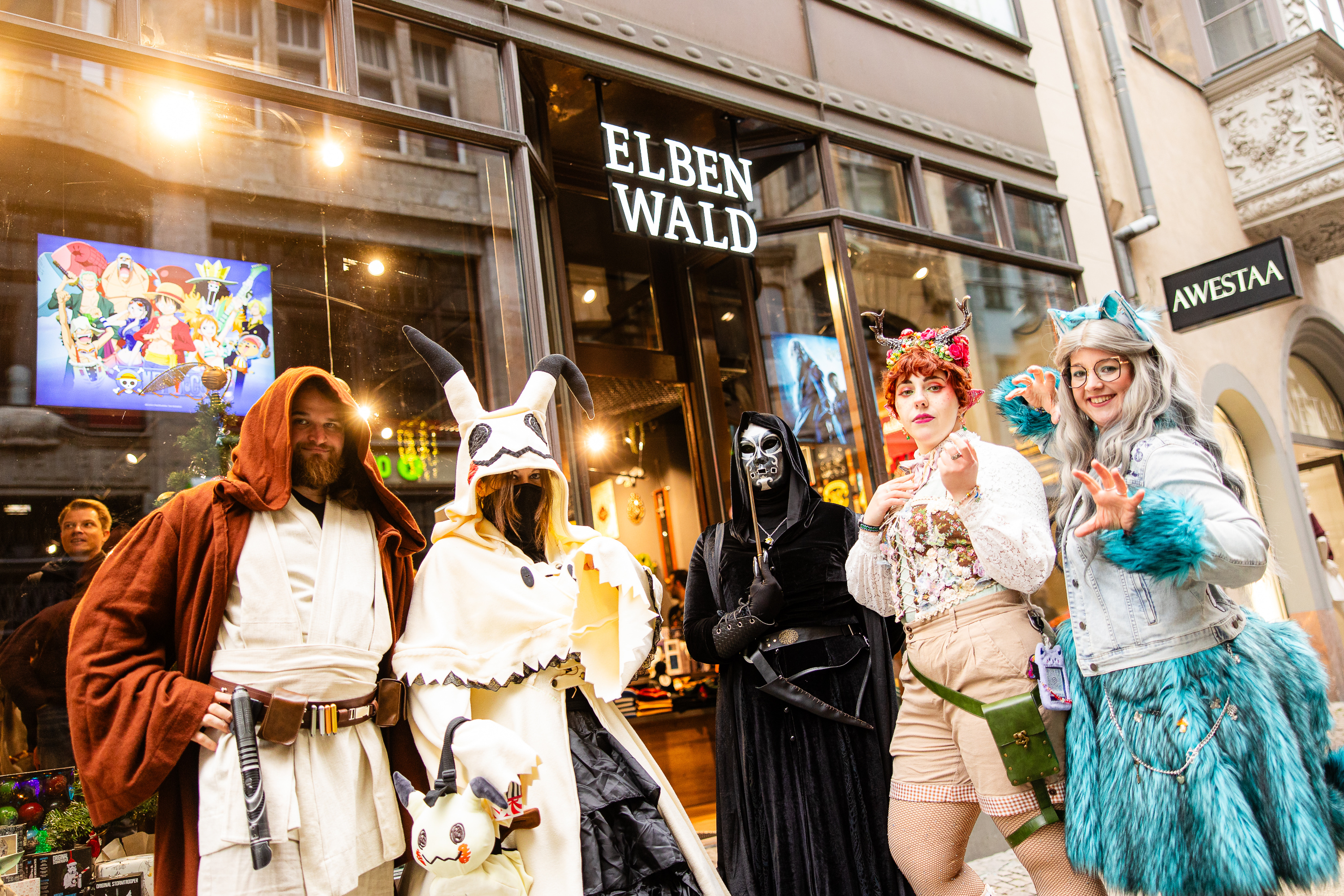 Un gruppo colorato di cosplayer davanti alla vetrina di Elbenwald.