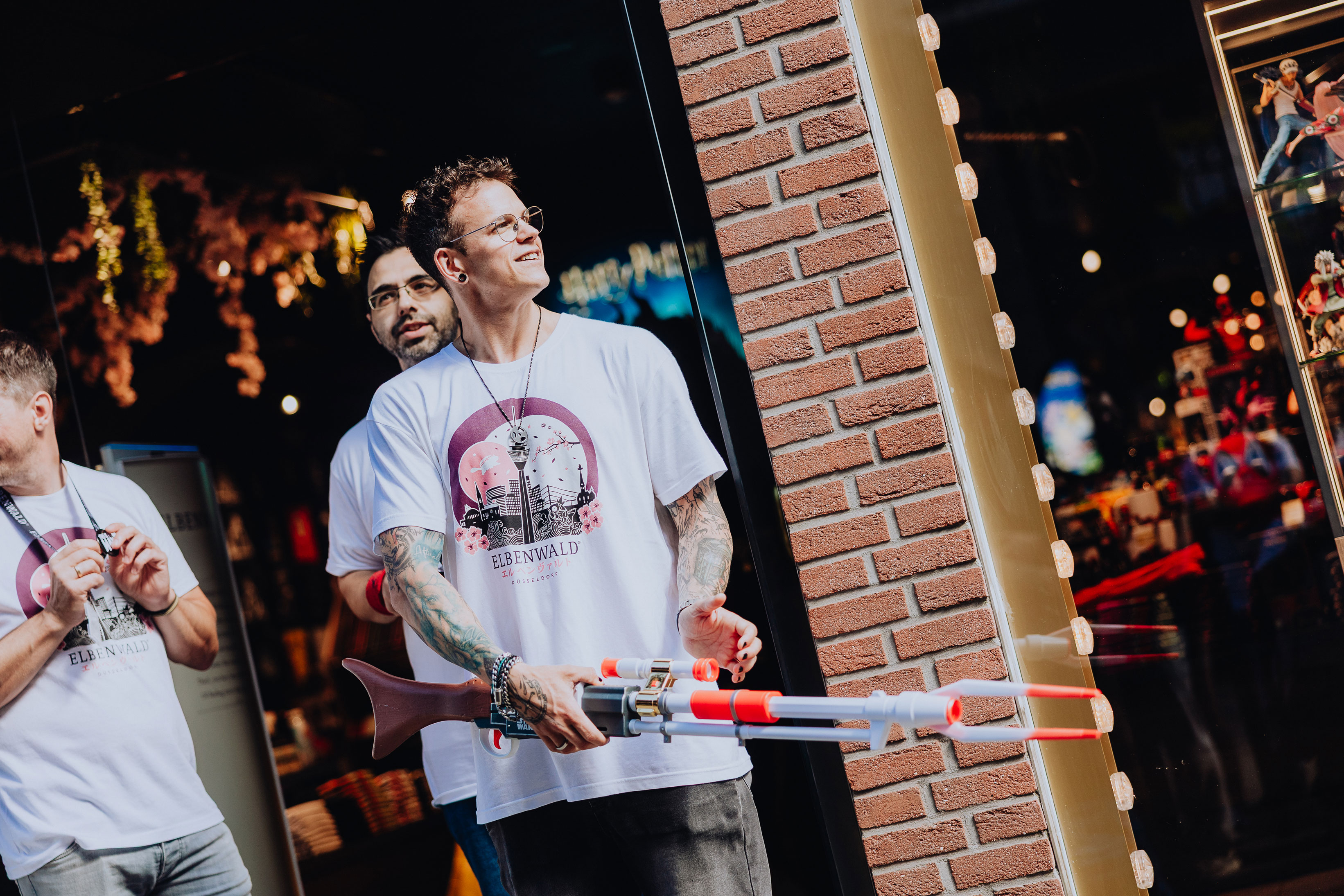 An Elbenwald employee cheerfully guards the entrance of the not-yet-opened store, holding a Nerf gun.